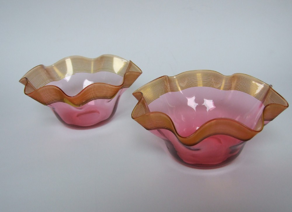 A lovely pair of Victorian cranberry frilled bowls with thread decoration.