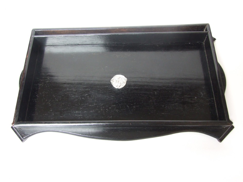 A handsome Edwardian ebony desk tidy with silver detail.