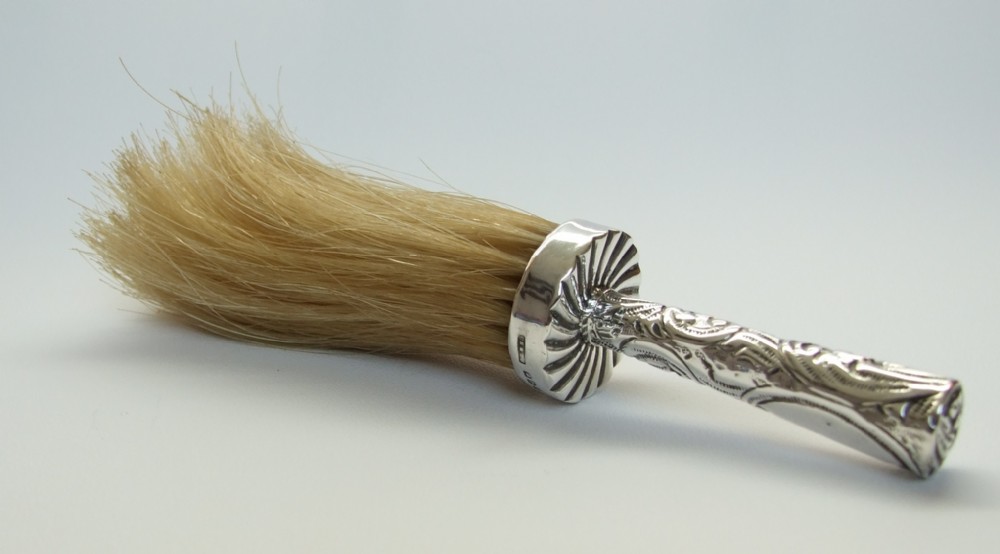 A rare Victorian silver hat brush.