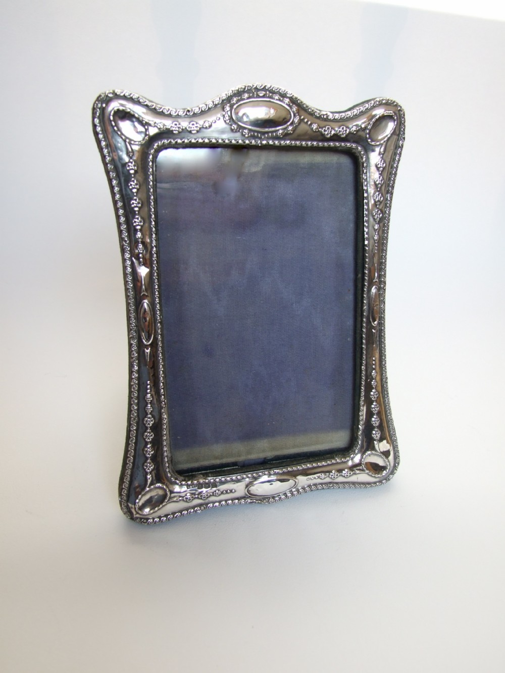 An attractive shaped silver photo frame.