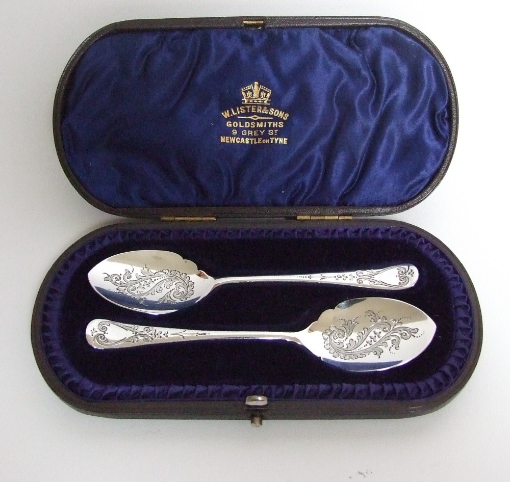 A charming pair of Victorian silver preserve spoons in the original box.
