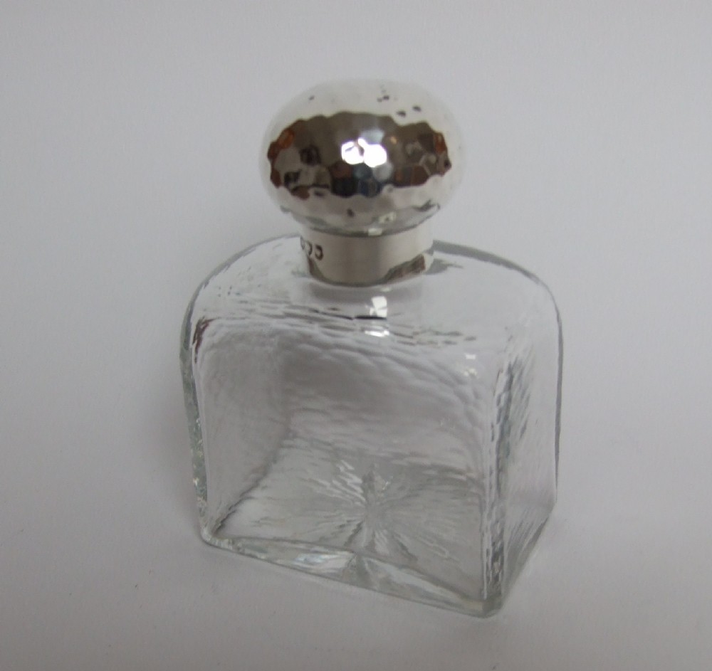 A gorgeous Victorian silver mounted cologne bottle in Arts & Crafts style.