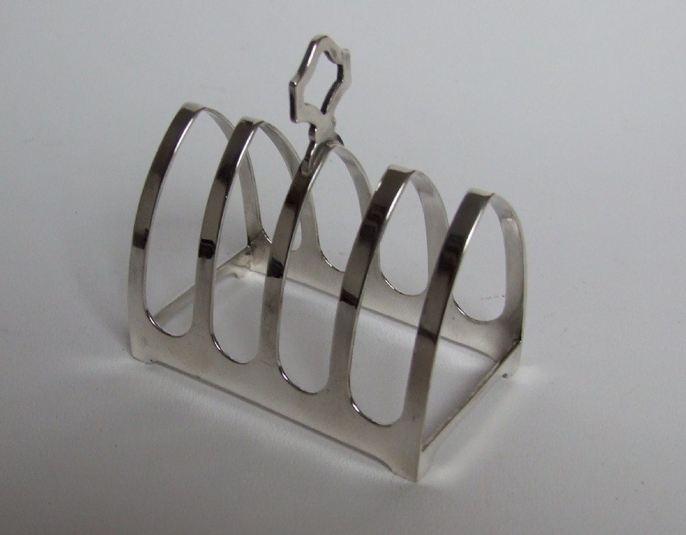 Charming Gothic style silver toast rack.