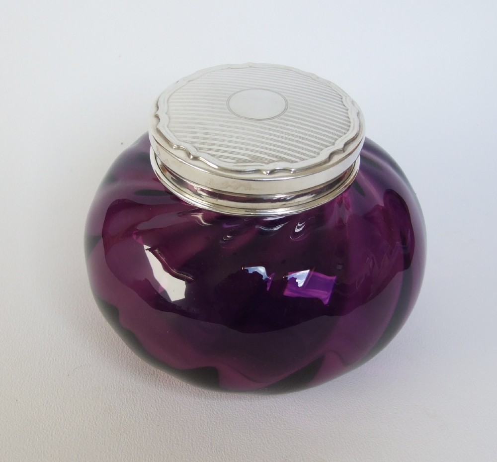 A wonderful silver topped powder bowl in amethyst glass.