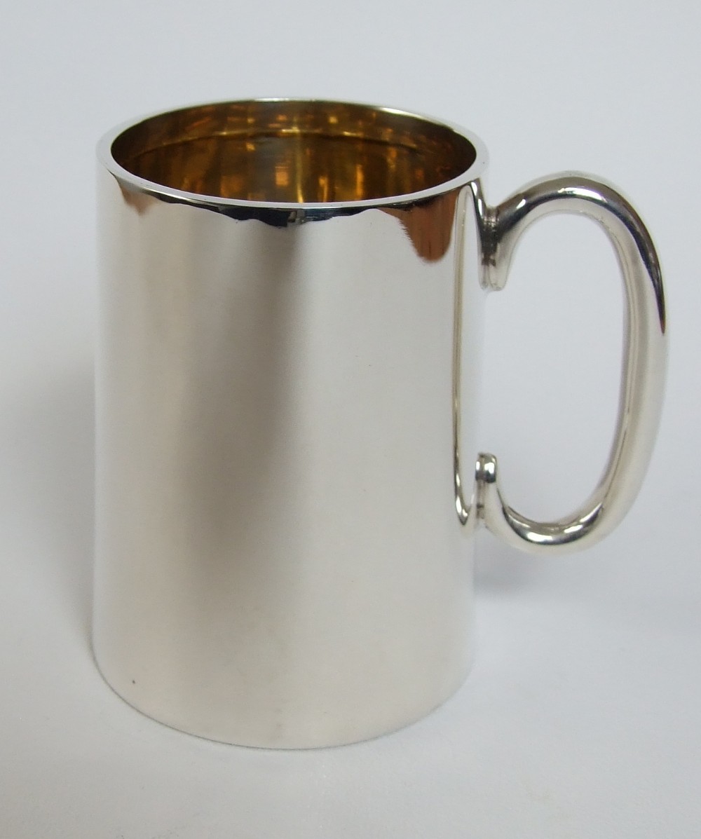A handsome Edwardian silver gilt mug.
