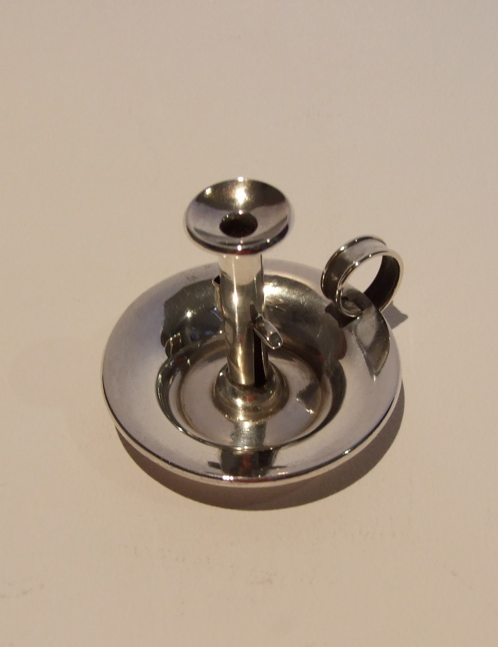 A charming miniature Victorian silver chamber stick.