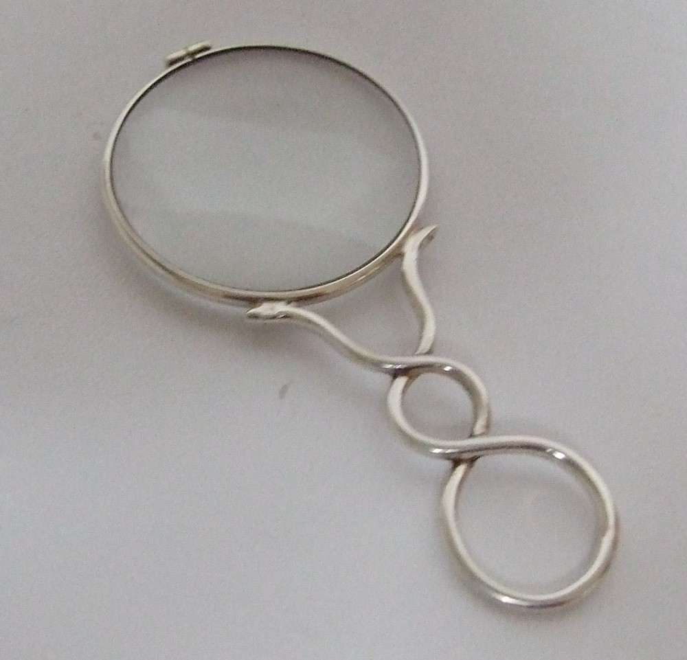 A charming Edwardian silver magnifying glass.