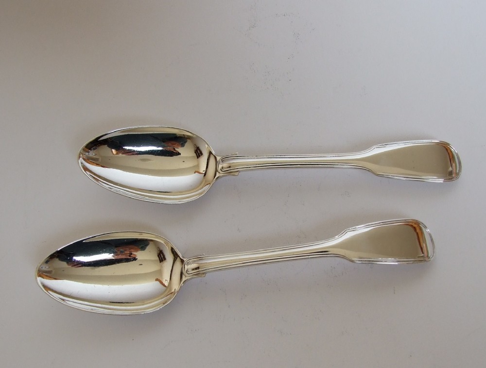 A pair of Victorian silver Fiddle & Thread dessert spoons.