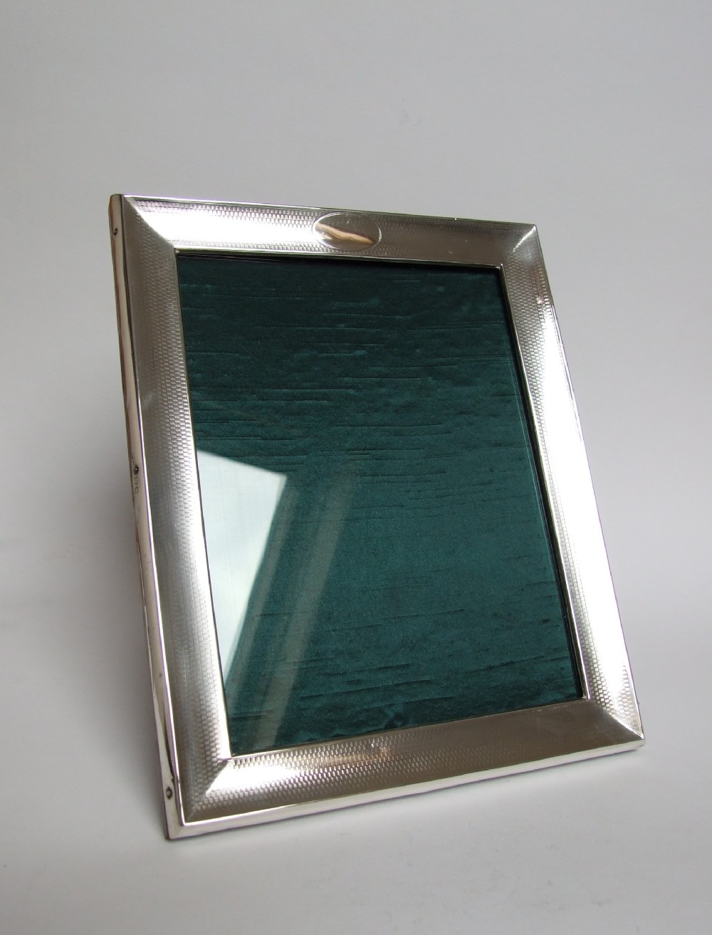 A handsome engine turned silver photo frame.