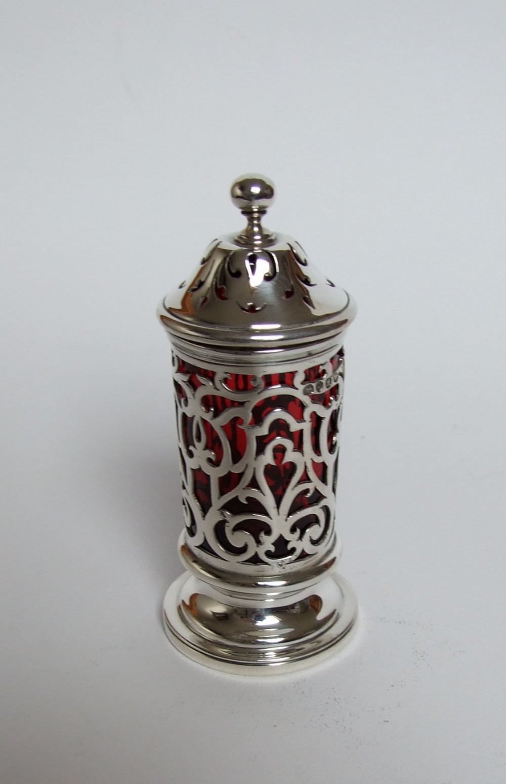 A rare early Victorian silver & cranberry pepper caster.