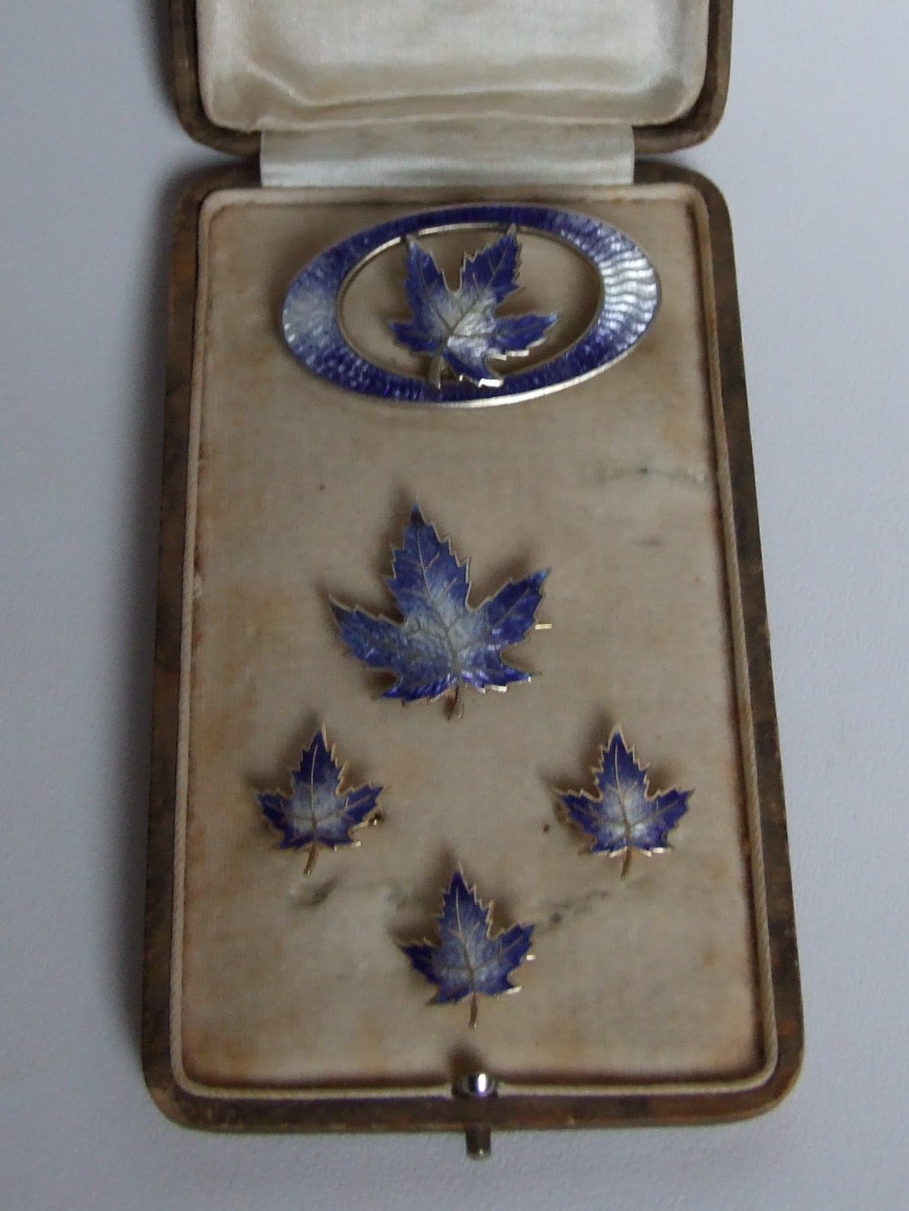 A rare silver & guilloche enamel boxed brooch set.