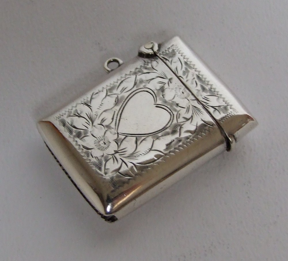 A charming Edwardian silver vesta with heart cartouche.