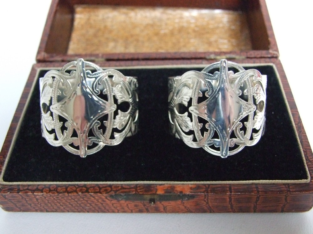 A stunning pair of boxed pierced silver napkin rings.