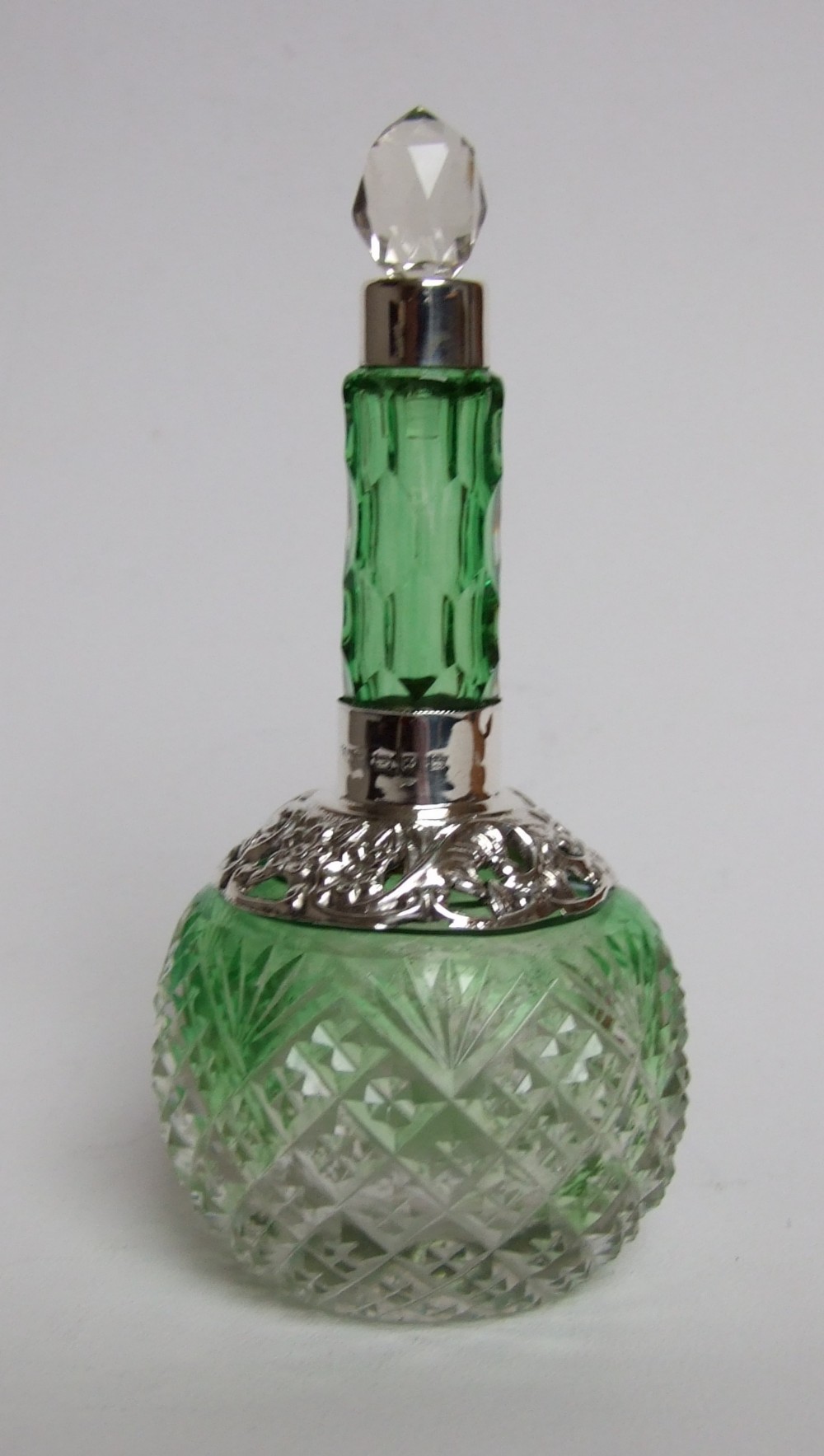 A delightful Victorian silver mounted perfume bottle.