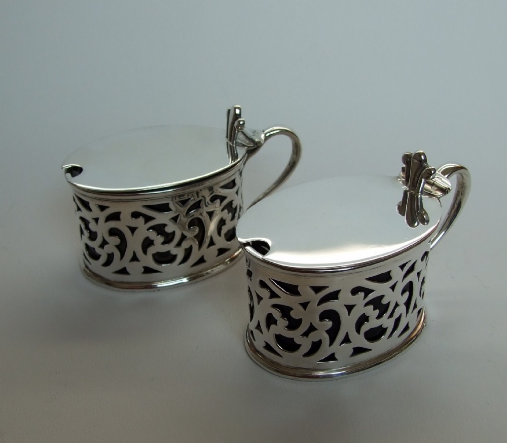 A rare pair of Victorian pierced silver mustard pots.