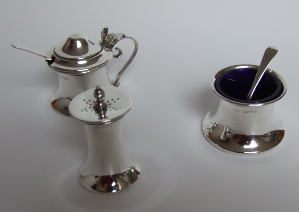 A charming George V silver three piece cruet.