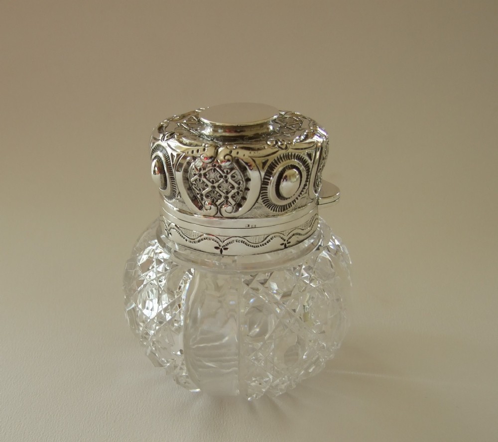 A spectacular silver mounted Victorian cologne bottle.