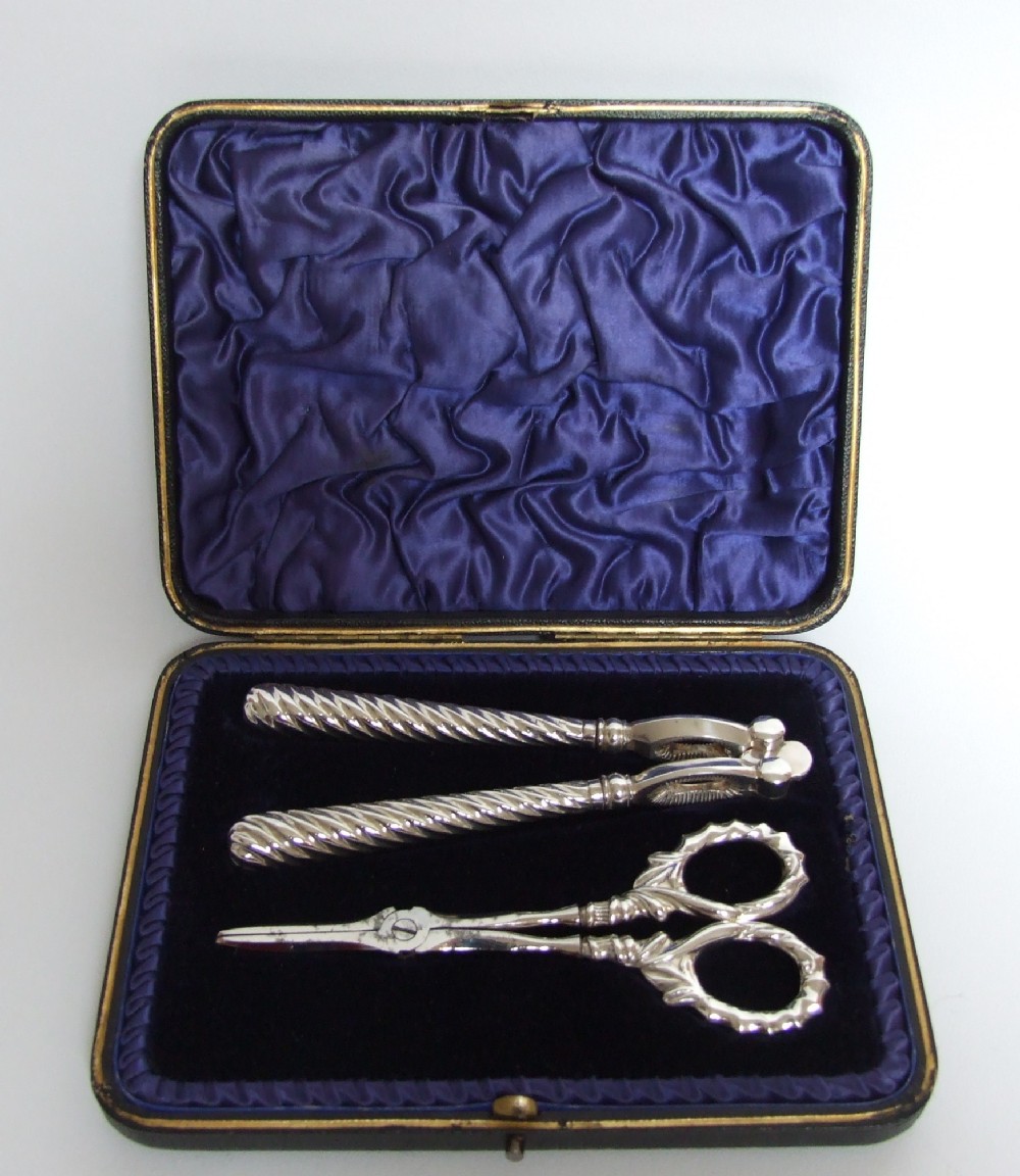 A wonderful boxed set of silver handled nut crackers and grape shears.