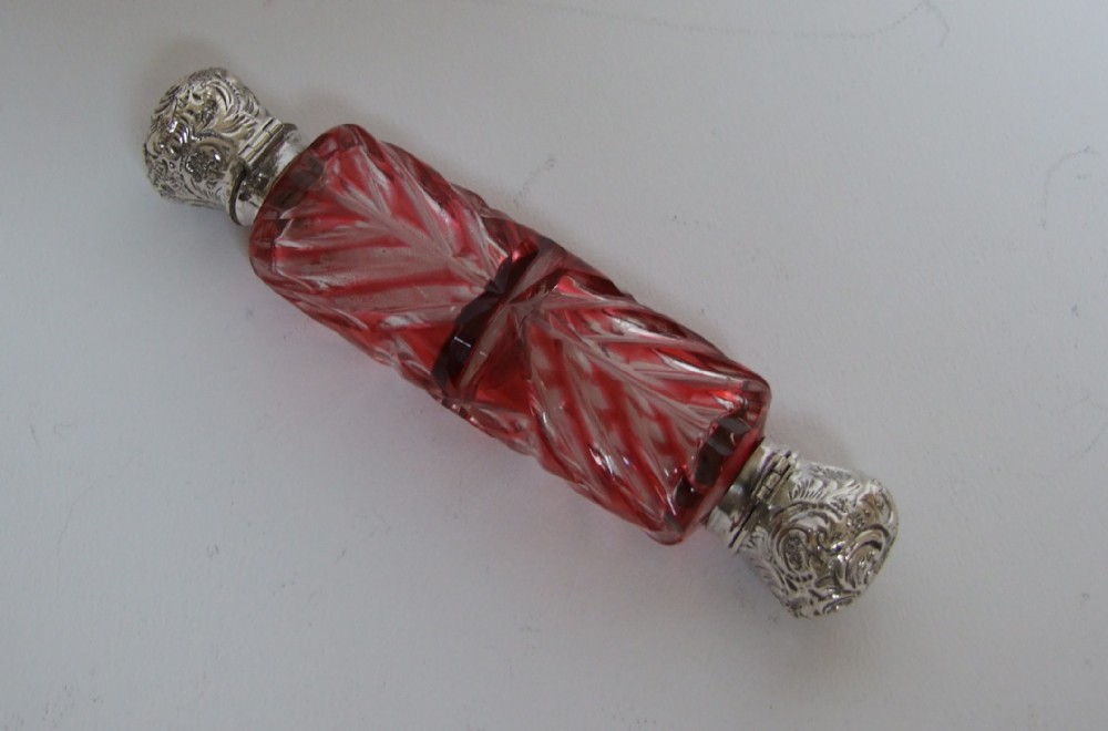 A rare double ended cranberry perfume bottle with silver mounts.
