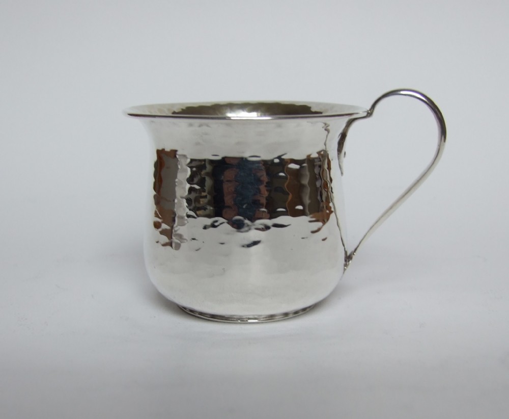 A wonderful hammered silver Arts & Crafts mug.