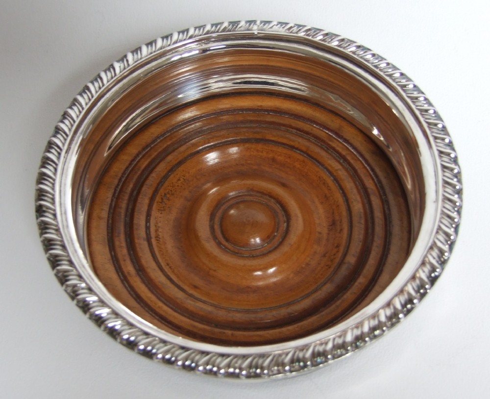 A Regency style Edwardian silver plated wine bottle coaster.