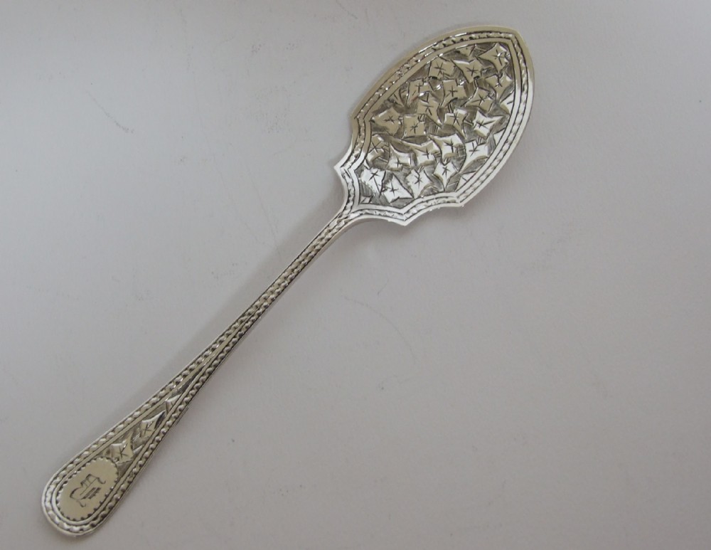 A handsome Victorian engraved silver preserve spoon.
