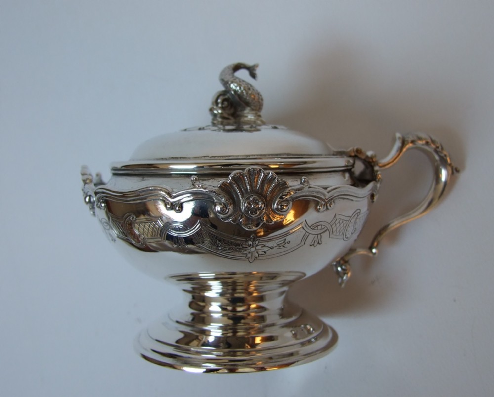 A fabulous silver mustard pot with nautical motifs.