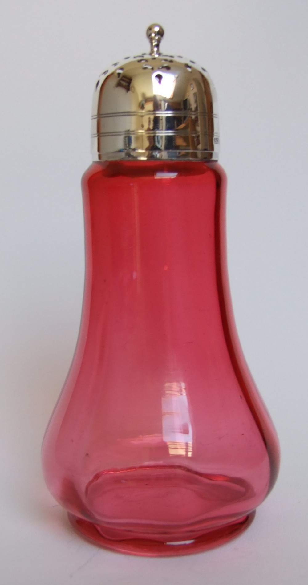 A delightful Edwardian silver and cranberry sugar caster.