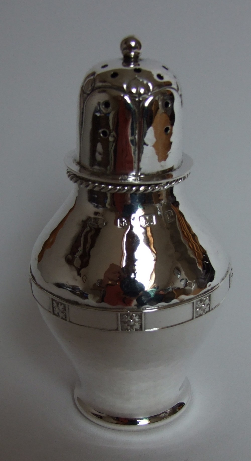A superb A E Jones Arts & Crafts silver caster.