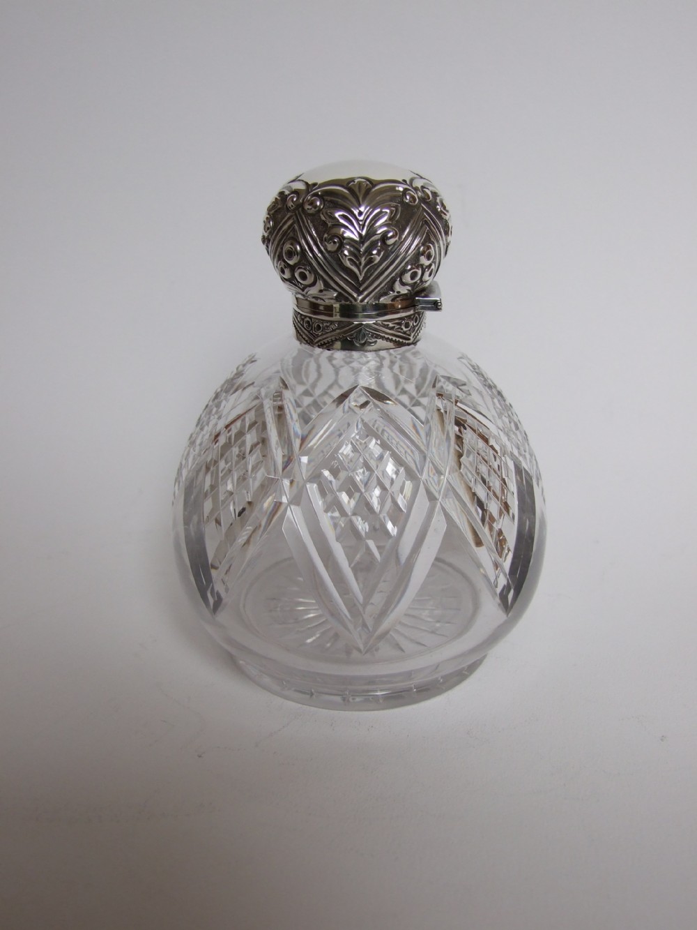 A superb Edwardian silver mounted cologne bottle.