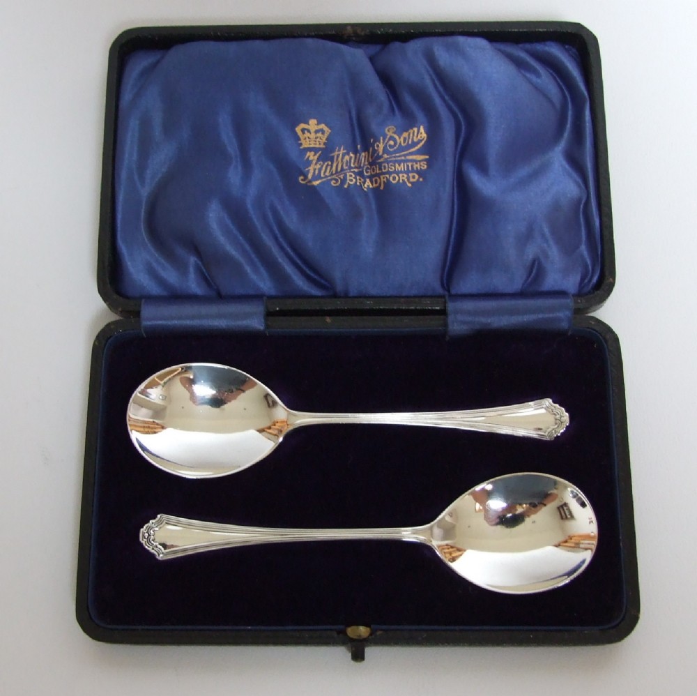 A delightful boxed pair of silver preserve spoons.