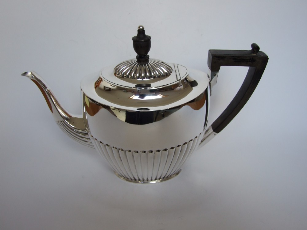 A full size Edwardian silver teapot.