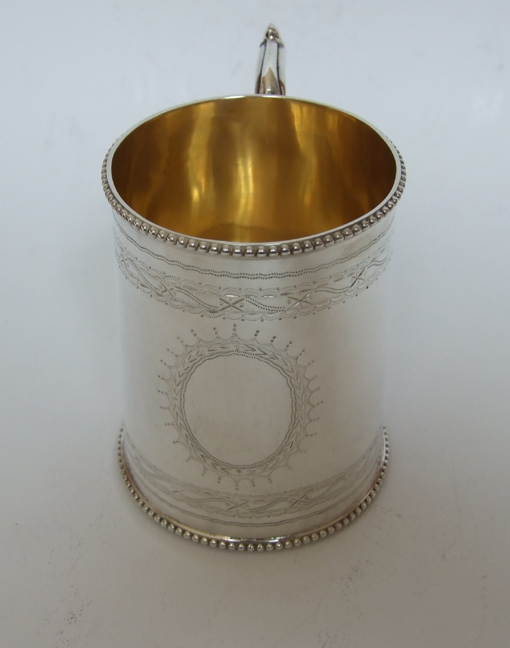 A superb mid Victorian silver gilt Christening mug.
