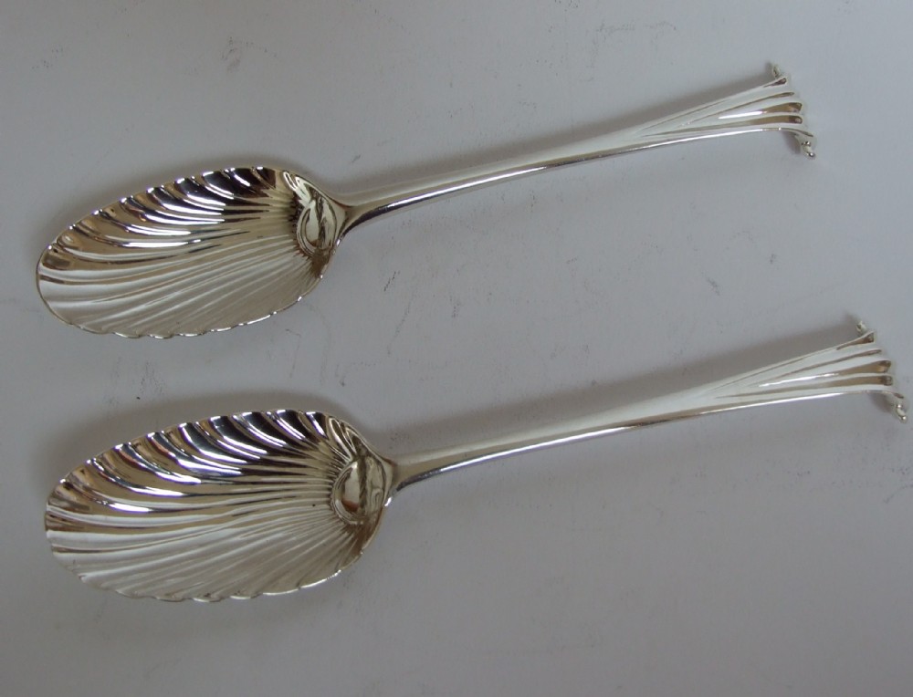 An extremely rare pair of George II Onslow pattern silver serving spoons.