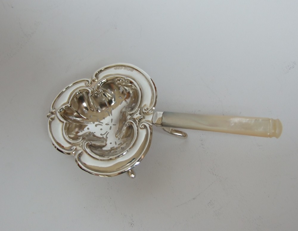 A gorgeous silver and mother-or-pearl tea strainer.