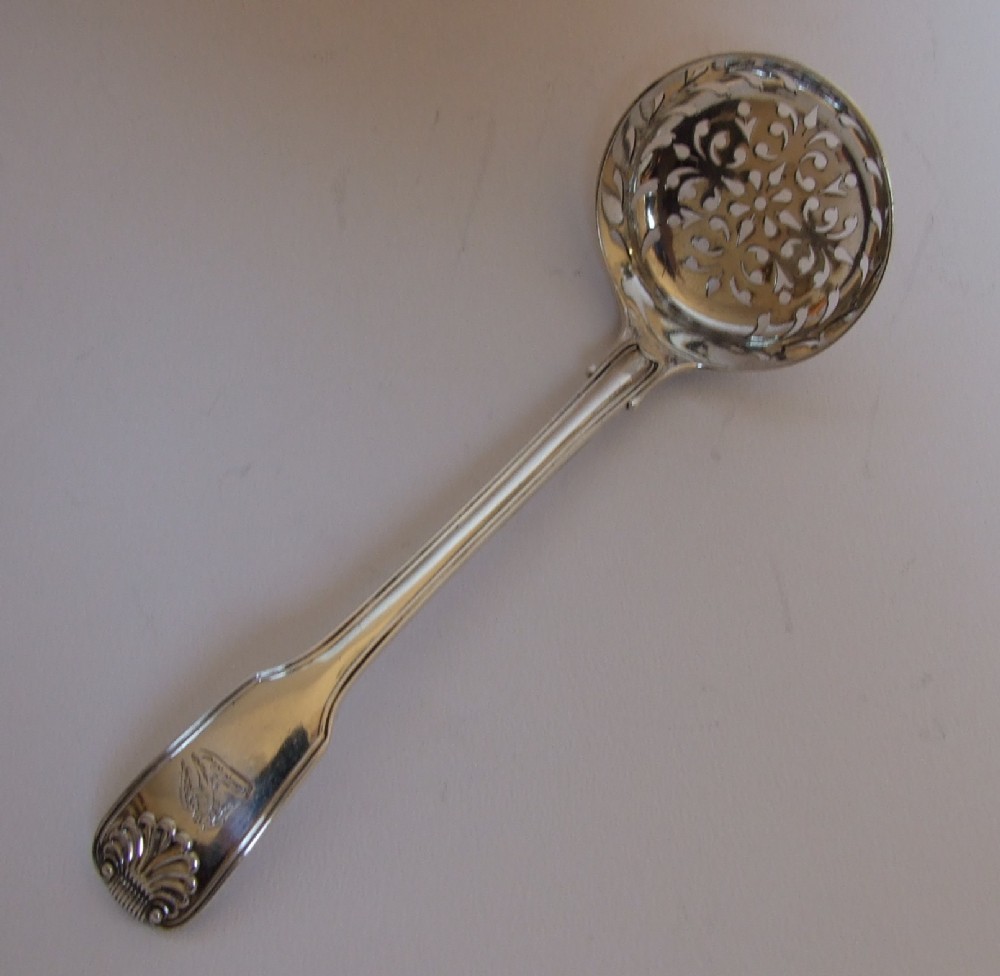 A superb George IV silver fiddle, thread & shell sifter spoon.