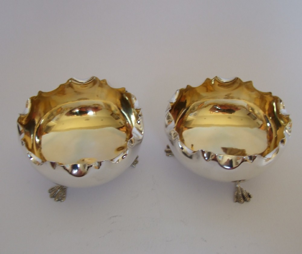 A fine pair of Edwardian silver gilt condiment tubs.
