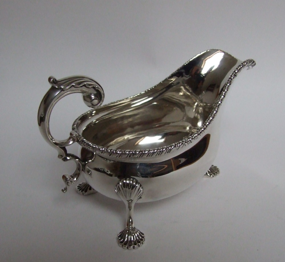 A handsome Edwardian silver gravy boat.