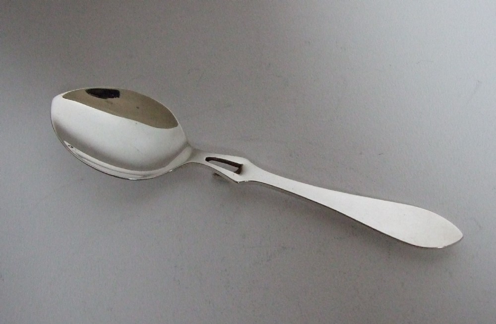 A rare silver honey spoon.