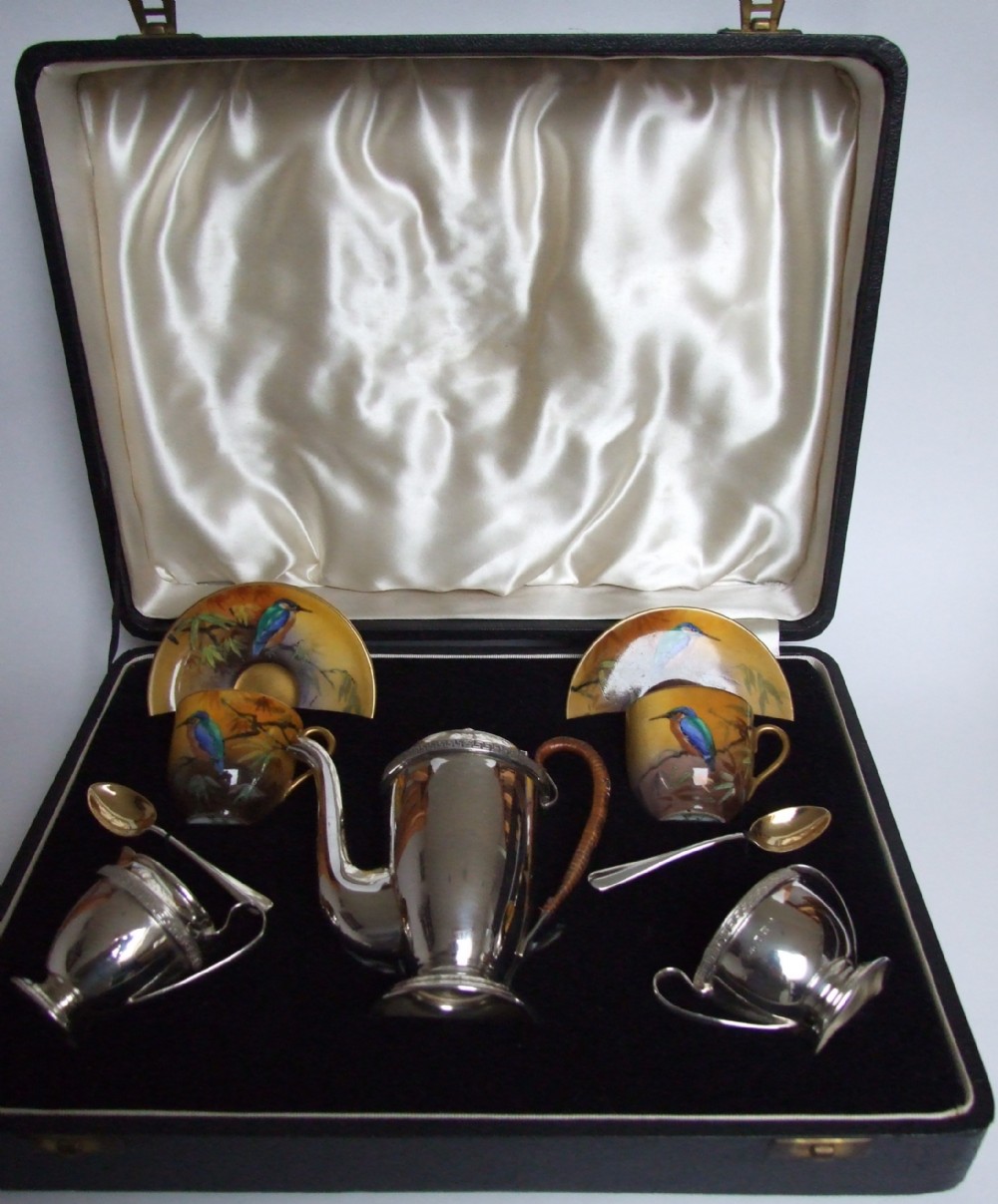 An outstanding boxed silver cafe a deux with Royal Doulton coffee cans and silver spoons.