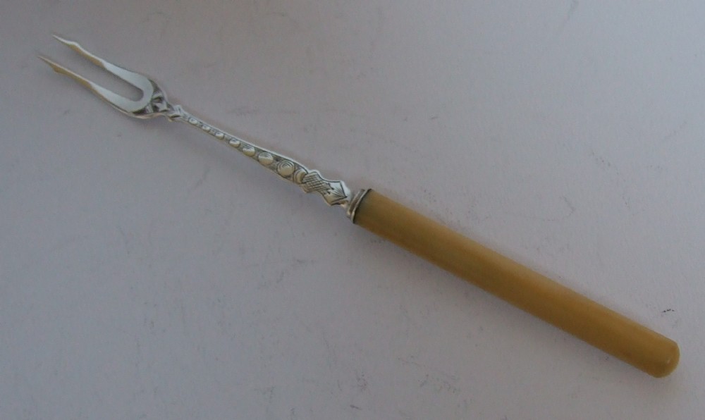 A gorgeous mid-Victorian silver pickle fork.