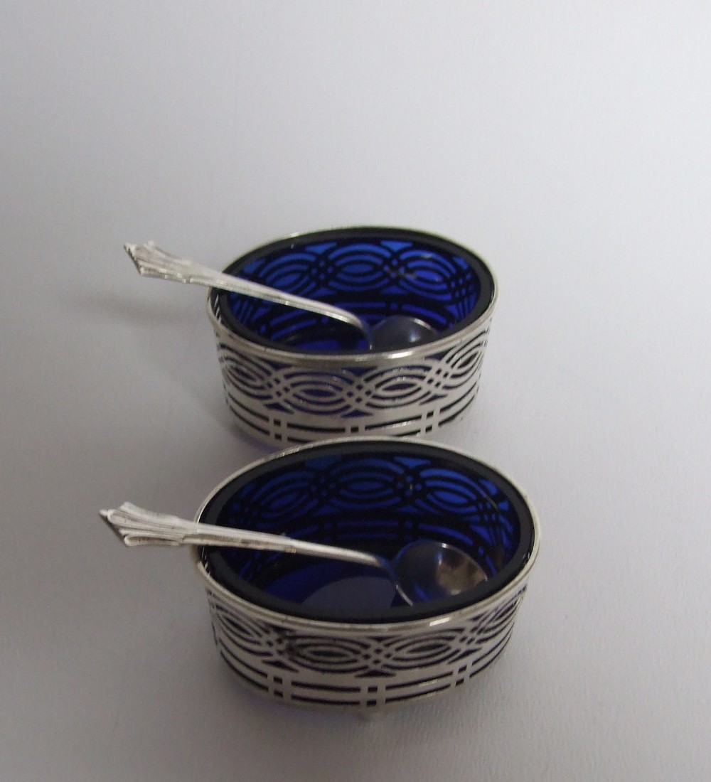 A gorgeous pair of Edwardian silver condiment tubs and spoons.