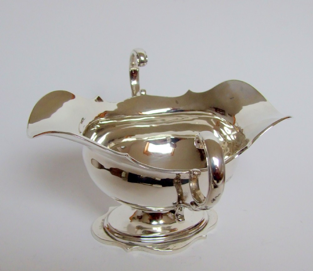 A handsome Edwardian silver gravy or sauceboat.