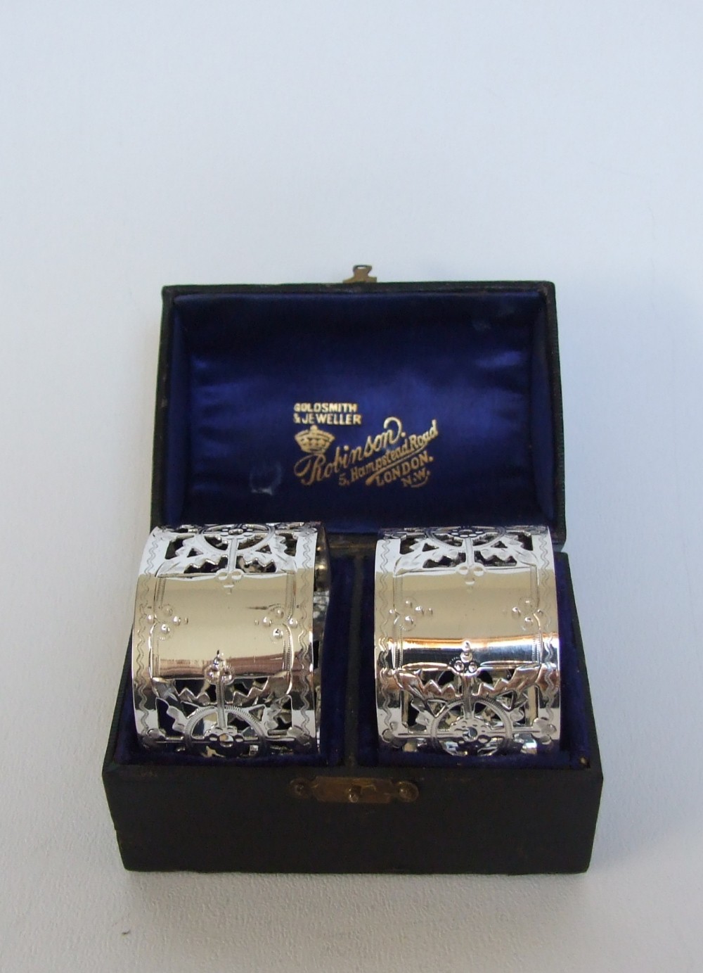 A gorgeous pair of Victorian pierced silver napkin rings in the original box.