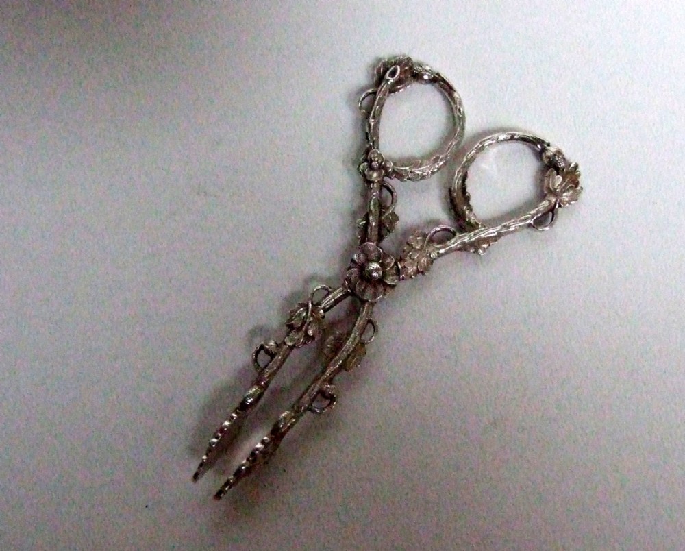 A stunning pair of silver naturalistic tea tongs.