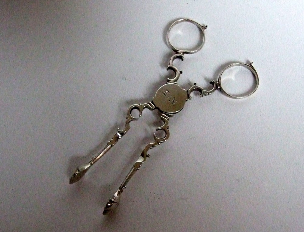A pair of 18th Century quatrefoil silver tea tongs.