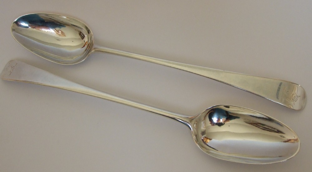 A rare pair of early George III silver stuffing spoons.