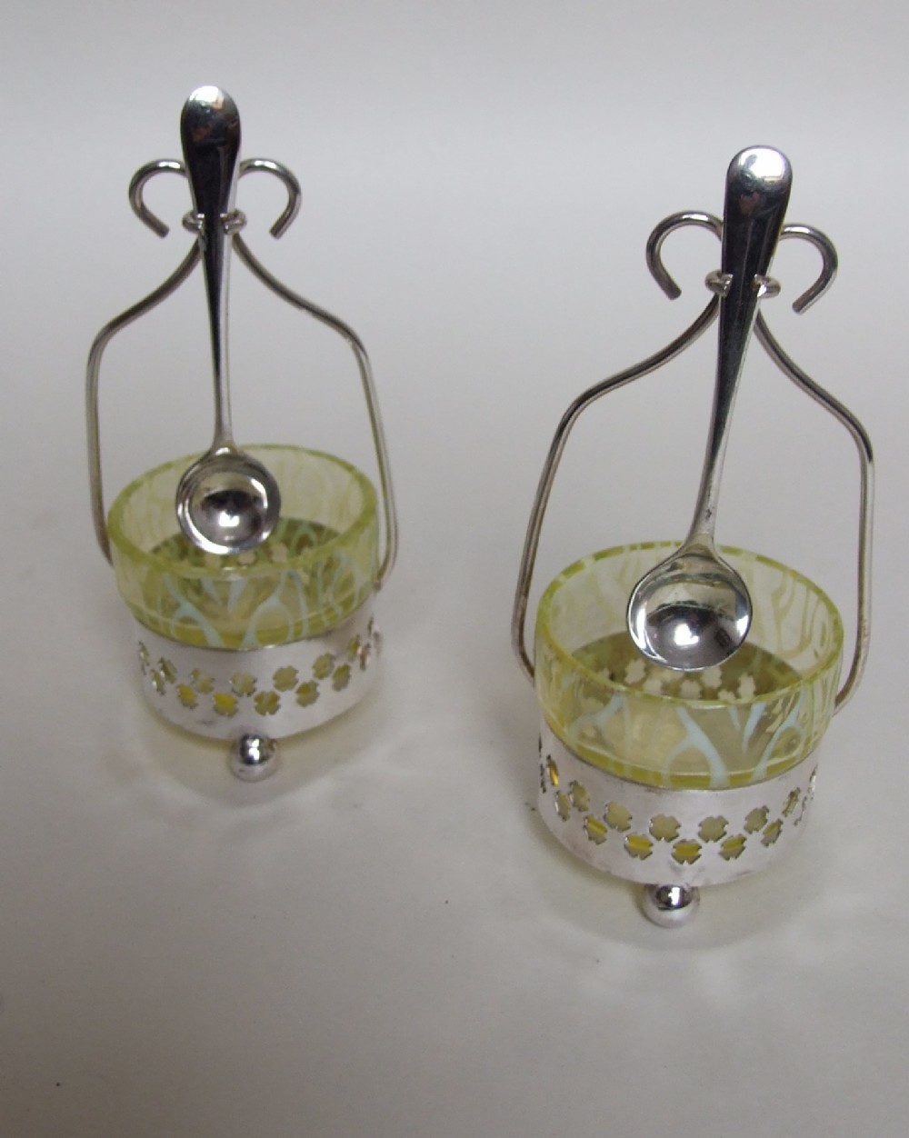 A pair of silver plated & glass condiment dishes