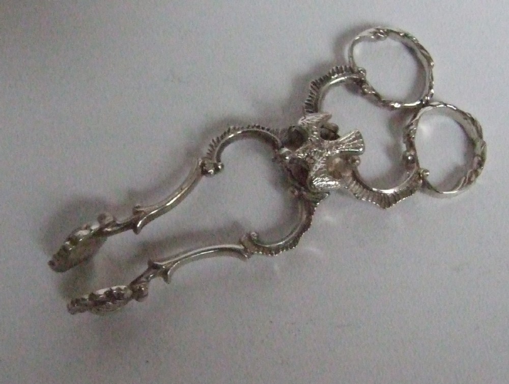 An unusual pair of silver tea tongs.