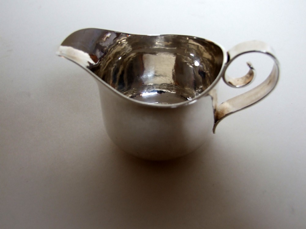 A fabulous Britannia standard silver cream jug in the Arts & Crafts style.
